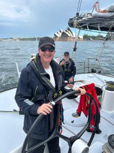 Man at helm of yacht